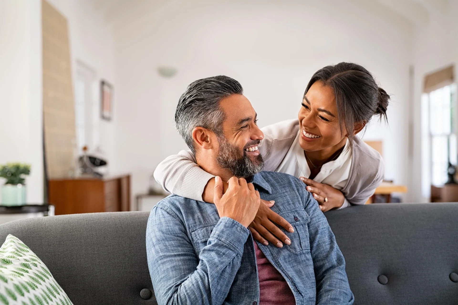 Smiling couple relaxing together on a sofa.