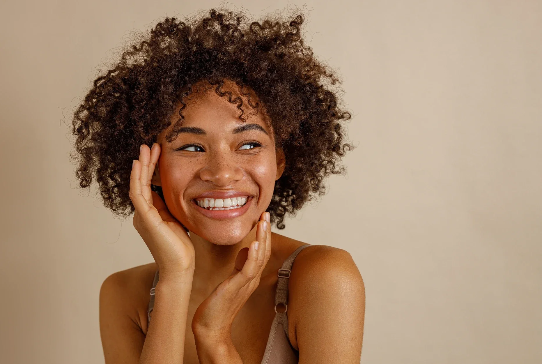Smiling woman with curly hair.