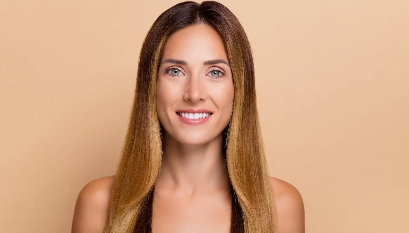 Portrait of a smiling woman with long straight hair.