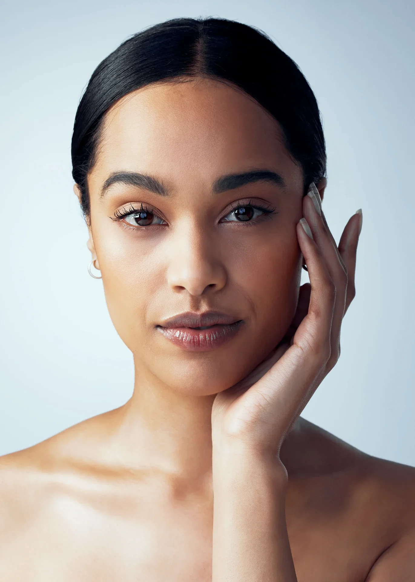 Woman resting her hand against her cheek.