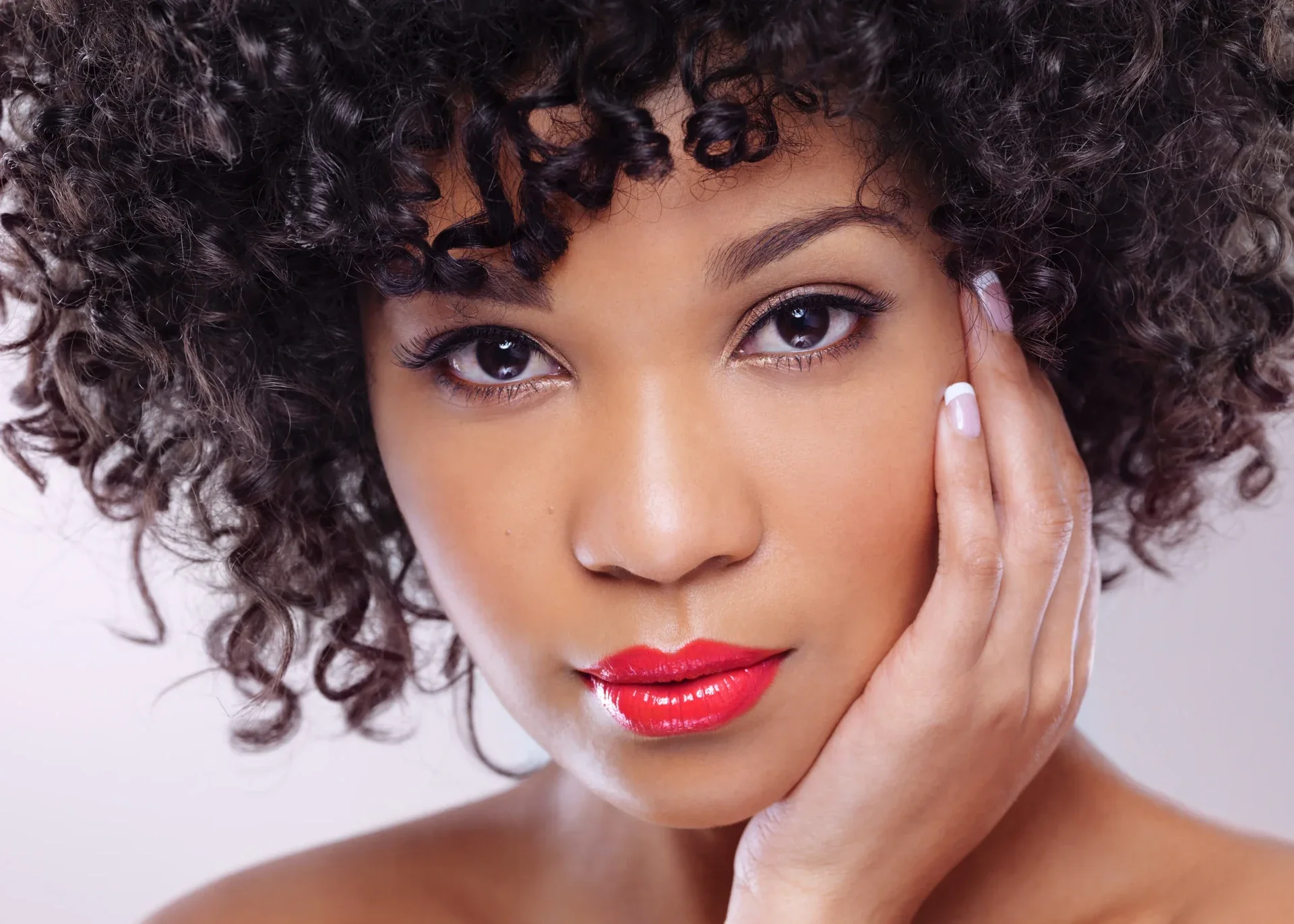 Portrait of a woman with short curly hair.